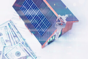 Eco-friendly miniature house model with rooftop solar panel, house keys, dollar bills and financial...