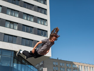 A girl jumps on an outdoor trampoline.