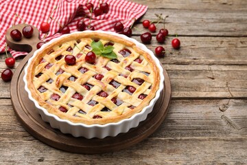 Tasty cherry pie on wooden table, closeup. Space for text