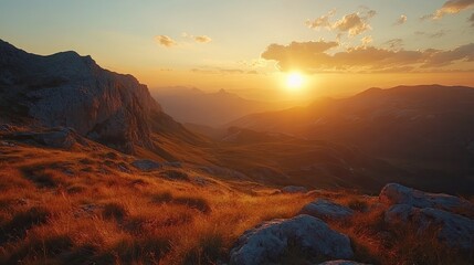 Naklejka premium Amazing bright sunset over rocky, cloudy mountain landscape during golden hour 