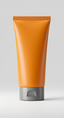 Sunblock tube with bold matte orange and neutral grey cap