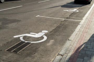 Parking spots designated for individuals with disabilities are visible along a busy urban street,...