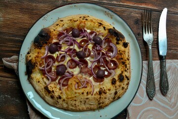 Authentic Brazilian pizza with calabresa sausage and onions baked in a wood-fired oven. Vera Neapolitan pizza