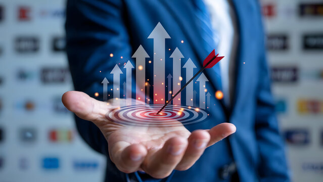 A businessman holds a target with arrows and rising graph in his hand, signifying success, achievement, growth, and reaching goals.