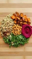 Fototapeta premium Vibrant Rainbow Veggie Bowl Recipe Roasted Sweet Potatoes, Chickpeas, Beetroot Hummus, and Quinoa