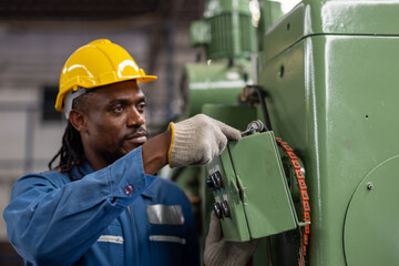 African american factory male worker. Engineer man worker in plant production drilling at robotic...
