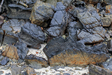Rock or stone rough texture surface on beach seashore. Nature landscape background. Summer travel destination.