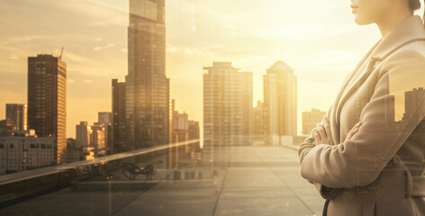 Woman in business attire stands with arms crossed overlooking a city skyline.