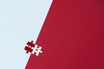 A concept photo illustrating Merger and Acquisition (M&A), represented by interlocking red and...