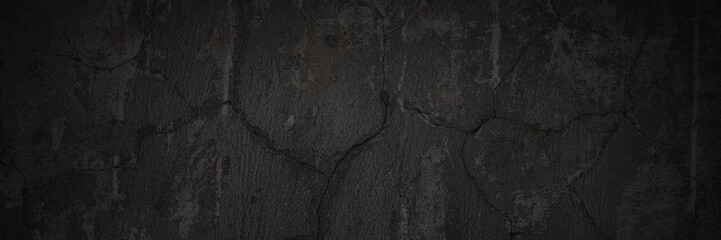 Texture of the old wall. Rough grungy surface of painted plastered concrete wall with spots, cracks, noise and grain. Dark wide panoramic background for design. Shaded vintage texture with vignette.
