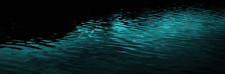 Black dark blue green teal water. Night. Ripples reflection light moonlight. Little waves. Gradient. Abstract. Contrast. Sea surface. Background with space for design. Wide banner. Panoramic.
