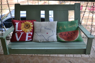 Poarch swing with colorful pillows at a lake cabin near Caddo lake, Texas