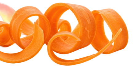 Carrot ribbons curl and twist in a vibrant display of fresh vegetable art