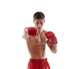 A focused young male boxer in red gloves and shorts. demonstrating a punching stance against a plain white background. showcasing determination and athleticism in a studio setting