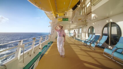 A woman is enjoying a sunny day on a luxurious cruise ship, strolling the deck, admiring the ocean views, and dressed in a chic outfit with a stylish hat, embodying elegance at sea
