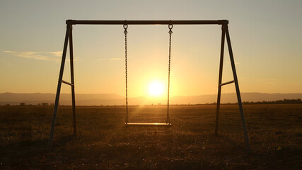 Empty swings invite childhood memories of summer fun in parks or by the beach