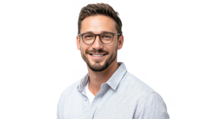 A smiling man with glasses wearing a light-colored shirt. posing against a plain white background. exuding confidence and approachability. ideal for professional profiles or lifestyle content