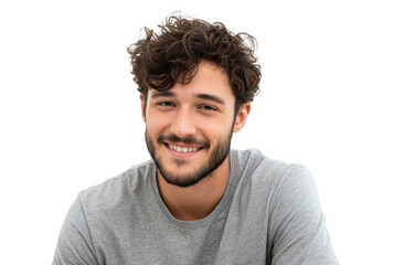 A young man with curly hair and a beard smiles warmly at the camera. showcasing a casual gray t-shirt. set against a plain white background. ideal for personal branding or lifestyle imagery