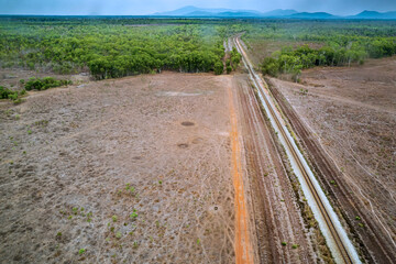 Aerial view of Railroad tracks crossing agricultural fields and woodlands near Sydney Airport,...