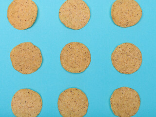 Round nachos carefully arranged on a light blue-green background