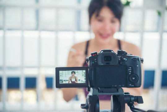 Asian influencer vlogger live review healthy lifestyle at home kitchen. Young woman blogger vlog happy lifestyle eating vegetables fruit vegan product. Healthy smile women social media vlogger live