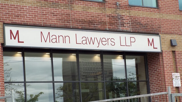 Ottawa, ON, Canada-June 29,2025: The sign for "Mann Lawyers LLP" at 11 Holland Avenue #300
