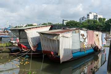 Vietnamese houseboats in sun at floating market early sunny morning. 