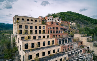 Aerial view of an abandoned mining and processing plant in a mountainous region