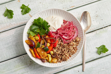 Seitan quinoa yogurt bowl with roasted vegetables and herbs