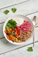 Seitan quinoa yogurt bowl with roasted vegetables and herbs