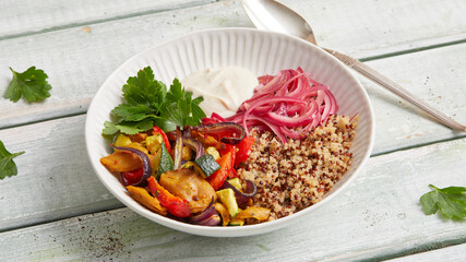Seitan quinoa yogurt bowl with roasted vegetables and herbs