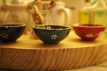 Colorful ceramic bowls arranged on a wooden table
