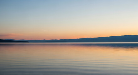 Fototapeta premium Lake reflects dawn light, over calm water, serene nature.