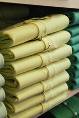 Green shirts neatly stacked in a retail display