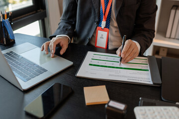 a businessman is reviewing accounting and financial statistics documents in his private office, the statistician prepares various charts and documents for a meeting