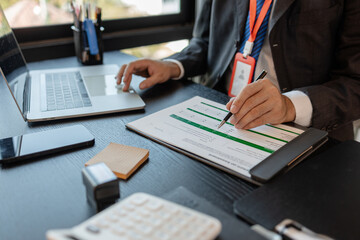 a businessman is reviewing accounting and financial statistics documents in his private office, the statistician prepares various charts and documents for a meeting