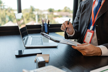 a businessman is reviewing accounting and financial statistics documents in his private office, the statistician prepares various charts and documents for a meeting