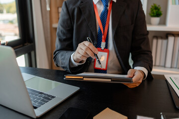 a businessman is reviewing accounting and financial statistics documents in his private office, the statistician prepares various charts and documents for a meeting