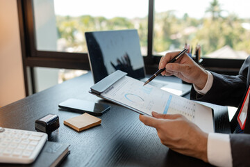a businessman is reviewing accounting and financial statistics documents in his private office, the statistician prepares various charts and documents for a meeting