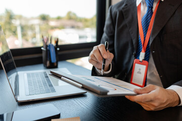 a businessman is reviewing accounting and financial statistics documents in his private office, the statistician prepares various charts and documents for a meeting
