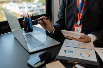 a businessman reviews the company's financial documents in his office, the accountant is rushing to check the figures in the documents before submitting them to the tax office