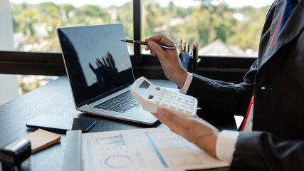 a businessman reviews the company's financial documents in his office, the accountant is rushing to check the figures in the documents before submitting them to the tax office