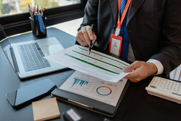 a businessman reviews the company's financial documents in his office, the accountant is rushing to check the figures in the documents before submitting them to the tax office
