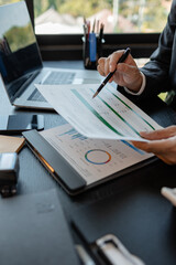 a businessman reviews the company's financial documents in his office, the accountant is rushing to check the figures in the documents before submitting them to the tax office