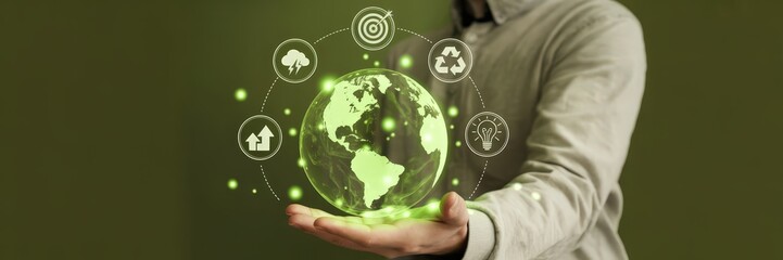 Person holds a digital representation of the earth with sustainability icons.