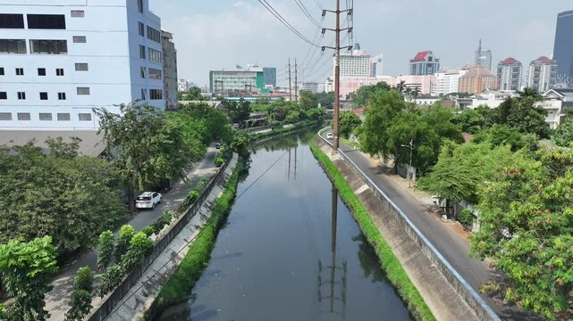 aerial view of a river in the middle of the city with concrete barriers on either side