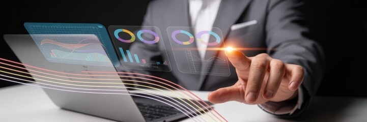 Businessman interacts with holographic data visualizations on a laptop.