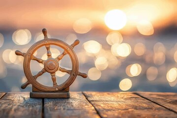 Wooden ship's steering wheel on a rustic wooden surface against a sunset background.