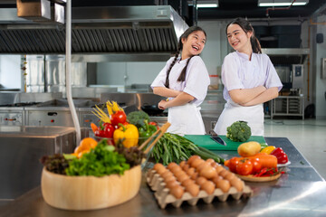 Culinary school student is posing inside the kitchen with fresh ingredient for cooking class school...