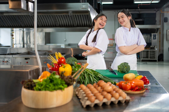 Culinary school student is posing inside the kitchen with fresh ingredient for cooking class school and education concept